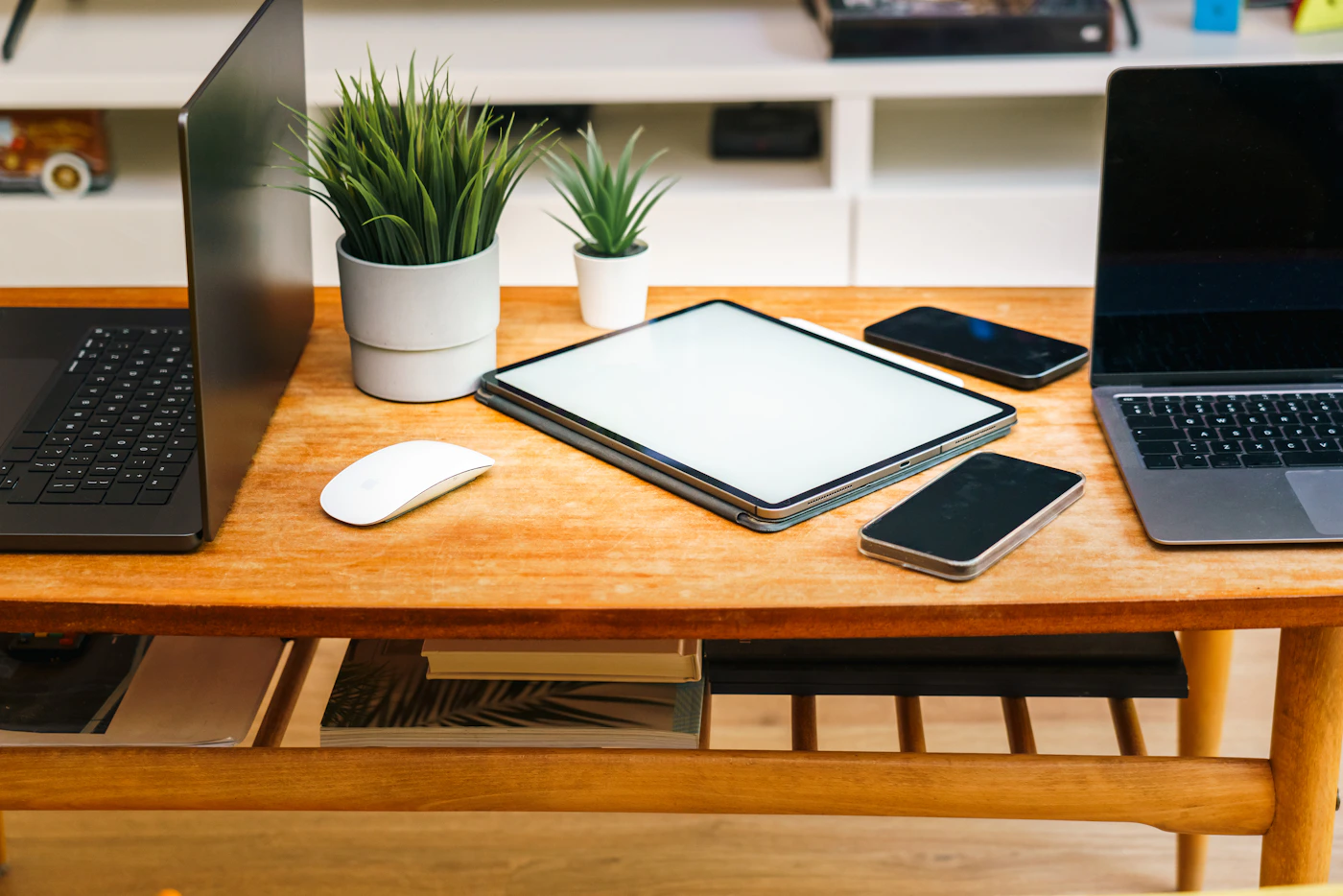 Real laptops, tablets and smartphones photographed together on a workspace desk